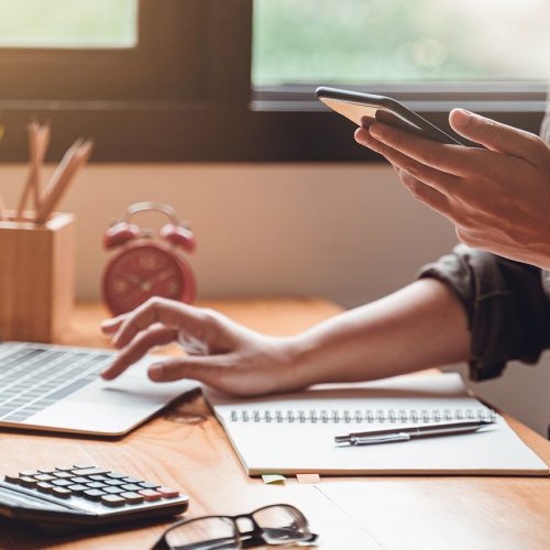 Cropped shot of young businesswoman working on a laptop computer in office at her home. Working at home concept